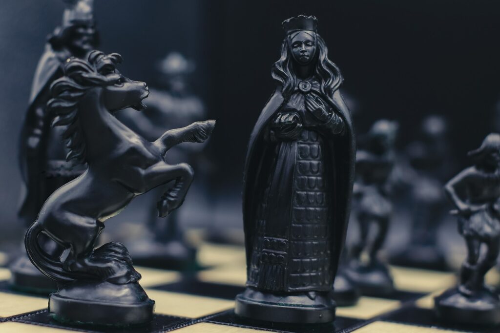 chess, black chess pieces, fantasy chess, strategy game, queen chess piece, knight, horse piece, battle of minds, board game, dramatic lighting, chess art, close up, intellectual game, royal game, strategic thinking, classic game, black queen, gothic style, elegant design, chessboard, mental challenge, dramatic game, vintage chess, fantasy warriors, tactical battle